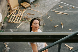 Ivana Kisic looks up the stairs into the camera