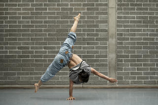 Hayato balanciert auf einer Hand im Tanzstudio
