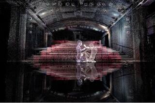 Eine 3D Installation eines Bühnenraums. Man sieht den Saal mit roten Stühlen. Auf der Bühne sind zwei durchsichtige Körper zu sehen, die auf der Bühne sich gegenübersitzen und sich berühren.